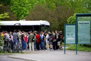 A group of visitors arrives by bus.